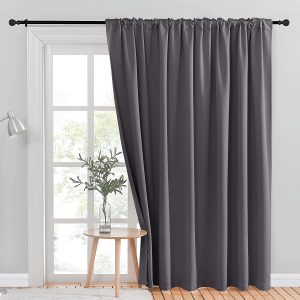 Image of curtains partially covering a full-length window
